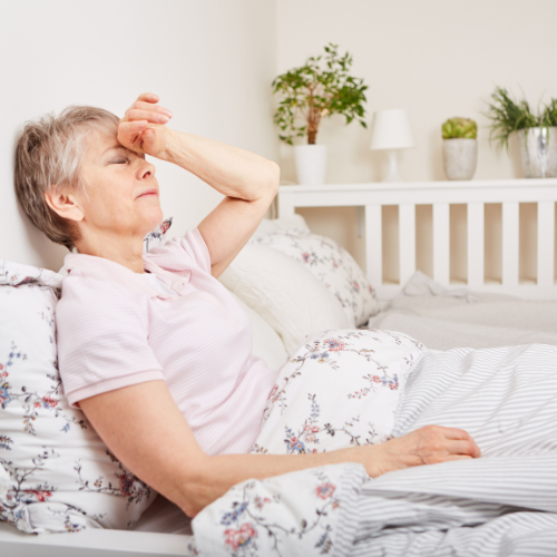 Senior Woman with Illness on Bed